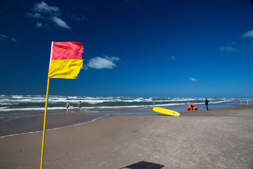 Lifeguard flags on a windy day at the beach on the west coast of Denmark