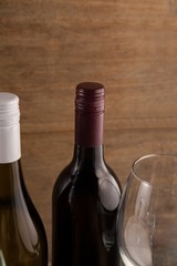 Cropped image of wineglass by bottles