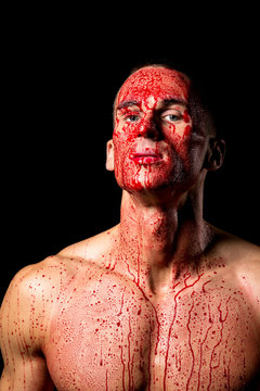 scary fitness muscular male model covered in blood