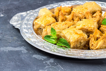 Jewish, turkish, arabic traditional national dessert. Macro. Selective focus. Baklava with honey and nuts