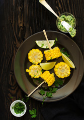 Cooked corn served with garlic butter. Selective focus. View from above.