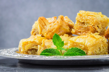 Jewish, turkish, arabic traditional national dessert. Macro. Selective focus. Baklava with honey and nuts