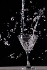 Vodka splashing in martini glass