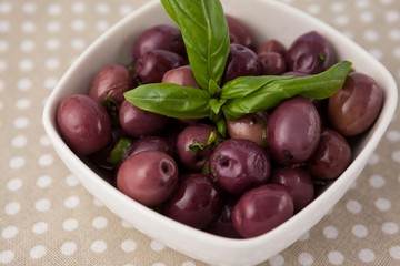 Close up of brown olives with herb
