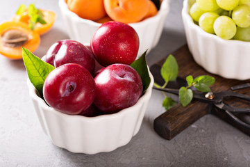 Various fruits in white bowls