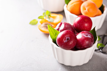 Various fruits in white bowls