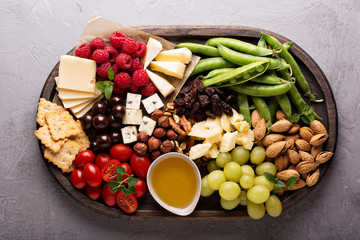 Cheese plate with fresh vegetables and fruits