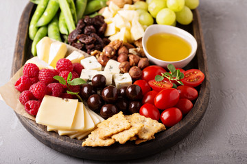 Cheese plate with fresh vegetables and fruits