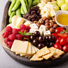 Cheese plate with fresh vegetables and fruits