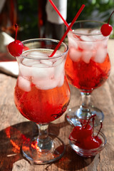 Glasses with tequila cocktails on wooden table