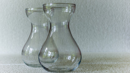 two glass flasks against a white background