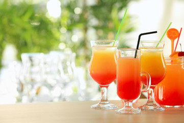 Glasses of delicious tequila sunrise cocktails on table
