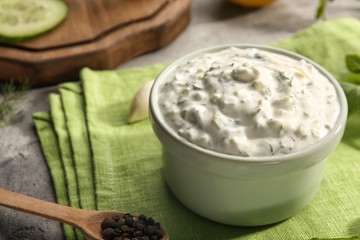 Delicious yogurt sauce in bowl on kitchen table