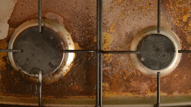 Washing a household stove by a man.