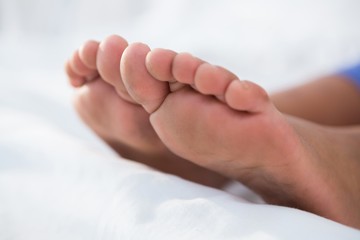 Close up of girl feet on bed