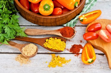 Spices and beautiful, fresh, bright vegetables on the table