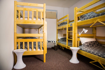 Interior of the hostel bedroom. Hostel with wooden bunk beds