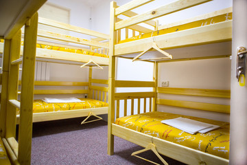 Interior of the hostel bedroom. Hostel with wooden bunk beds