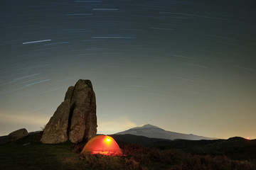 Stars Trails On Lighting Tent In Argimusco Highland, Sicily - 163511797