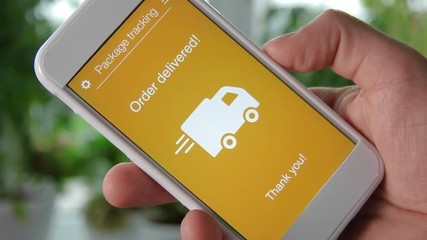 Man tracks his package using smartphone application. Order delivered. - Powered by Adobe