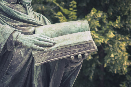 Hands holding open book  -  person reading book