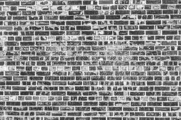 Old brick wall background. Grunge texture. Black wallpaper.