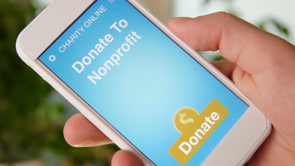 Man making an online donation to nonprofit organization using charity applicaiton on smartphone
