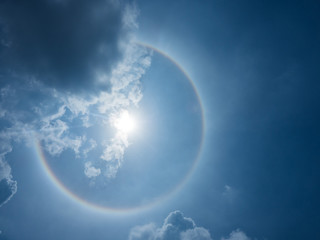 Obraz na płótnie Canvas Circular Sun Halo in blue sky and cloud color like rainbow
