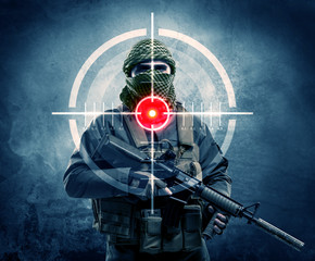 Masked terrorist man with gun and laser target on his body