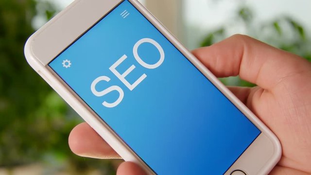 SEO concept application on the smartphone. Man uses mobile app.