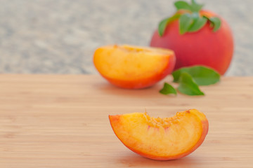 Naklejka na ściany i meble Ripe peaches on cutting board.