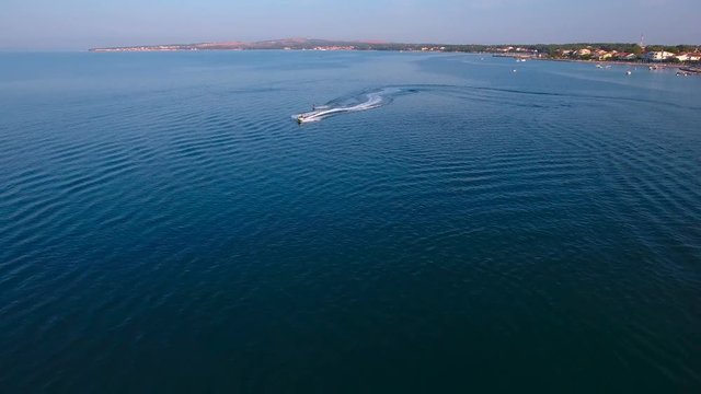 Scooter and wake boarder speeding towards the camera 4K