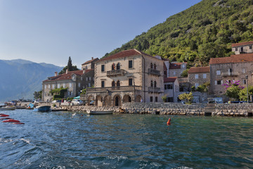 Fototapeta na wymiar Small towns on the shore of the Kotor Bay attract many tourists