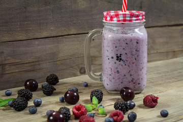 Smooties  in a jar with a lid and a straw