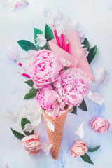 Ice cream waffle cone with peony flowers, letters, leaves, stationary and a pink envelope