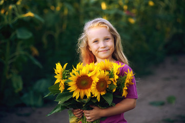 Portrait of a girl with a bouquet of sunflowers .