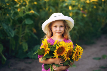 Portrait of a girl with a bouquet of sunflowers .