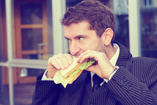 businessman is eating bread