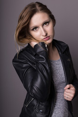Fototapeta premium Frau im Studio mit schwarzer Lederjacke