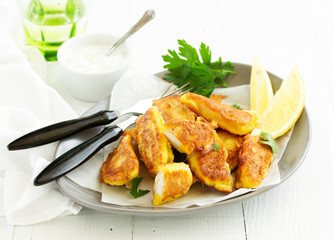 Fish fried in a dough with white sauce.
