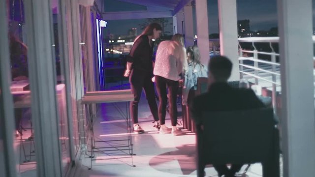 People gathered on the balcony at night