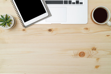 Workspace home office wood table with notebook and coffee. Top view with copy space, flat lay.