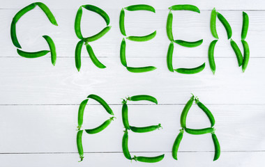 Top view of fresh green peas in pods on white background, free space, Food background, flat lay