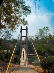suspension bridge across Kwai river connect the other side for watching Sai Yok Yai waterfall
