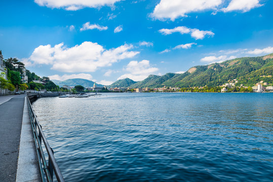 Como lake, Como city, northern Italy. View of Como city on a beautiful summer morning. To the left the lakefront promenade