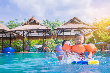 happiness father and son  in swimming suit having fun in swimming pool