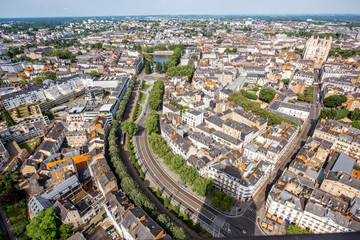 Aerial cityscape view with beautiful buildings and wide avenue in Nantes city during the sunny weather in France