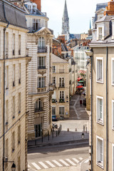 Street view on the beautiful residential buildings andchurch tower in Nantes city during the sunny day in France