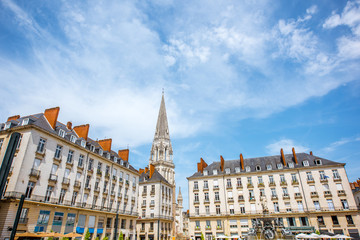 Fototapeta na wymiar View on the Royal square with fountain and church tower in Nantes city in France