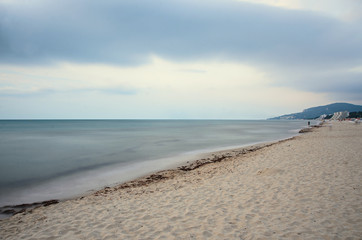 The Black Sea shore from Albena, Bulgaria with golden sands, sun, blue mystic water, umbrellas and sunbeds